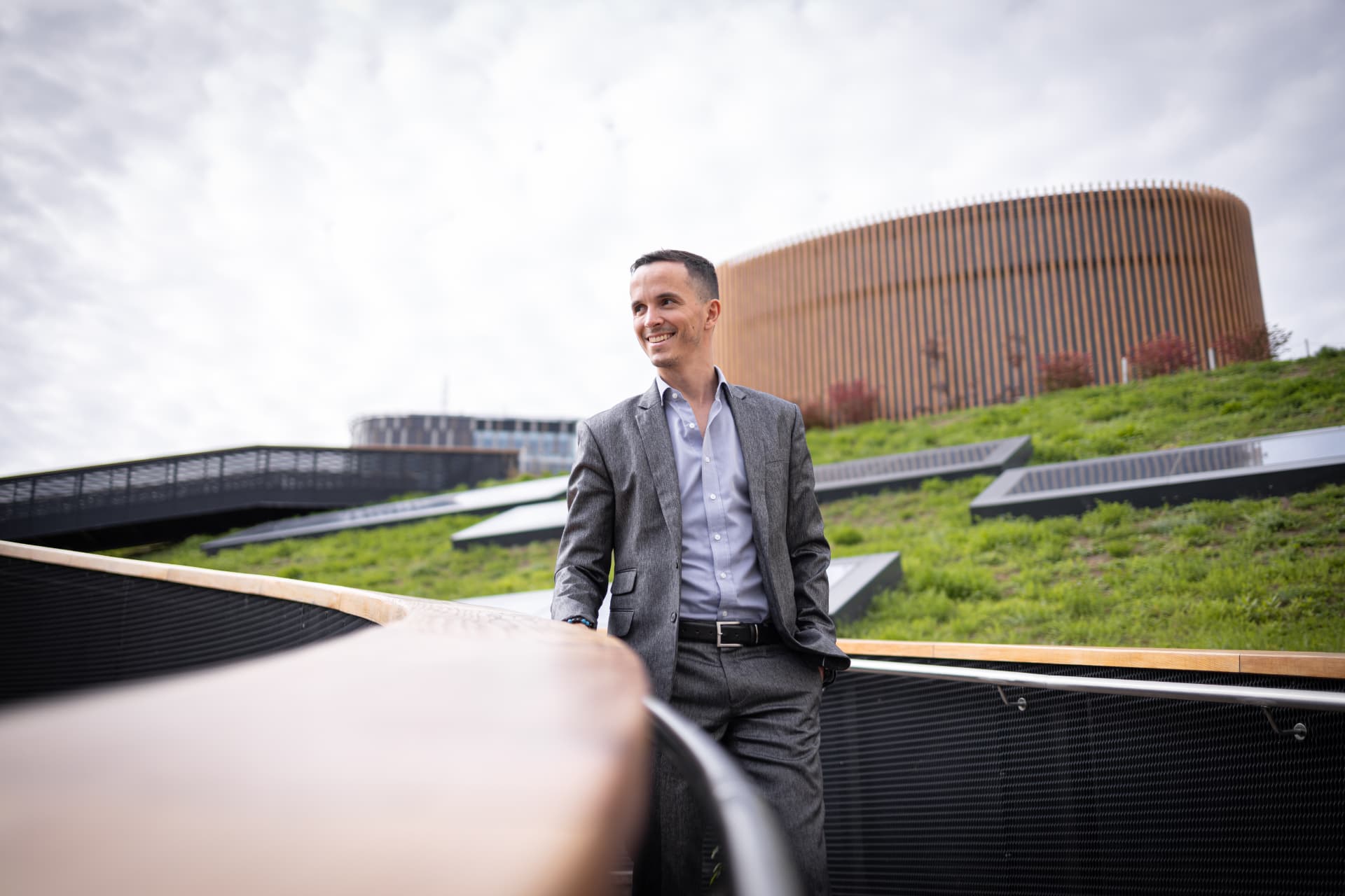 Maros Cincura walking outside a modern building